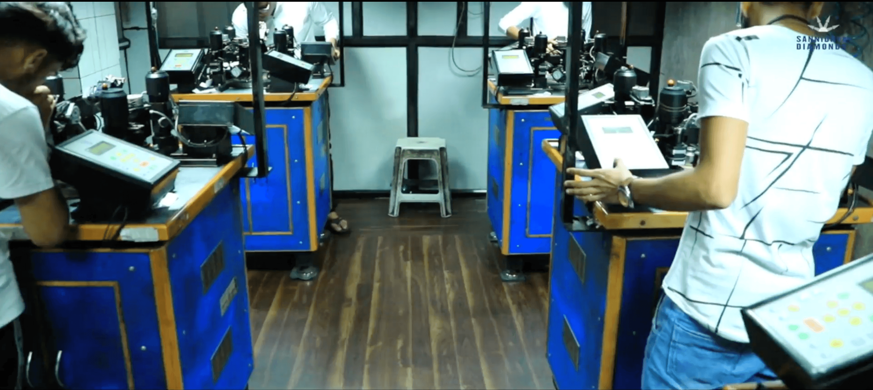 Rows of operators working at automatic diamond polishing stations